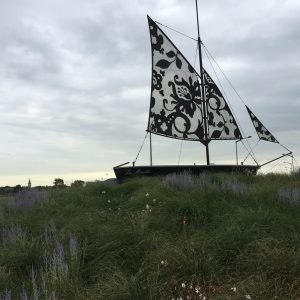 The Boat of Calais, La Mouette, The Seagull, with lace sail signaling renowned lace trade employing migrant labor, 2017